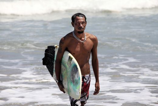 Surfer on a coastline. Bali, Indonesia
