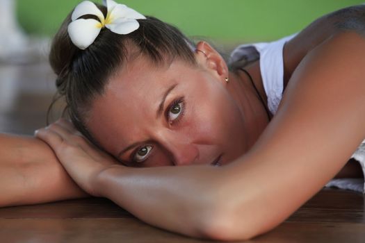 Portrait of the beautiful girl with a flower in hair