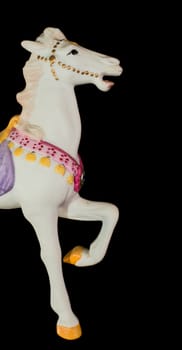 Colorful carousel horse isolated on black background