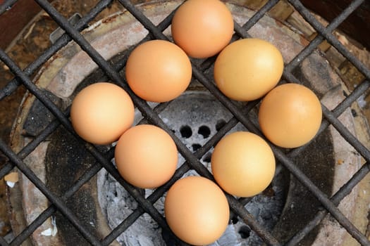 Grilled chicken eggs over stove gridiron and low heat. 