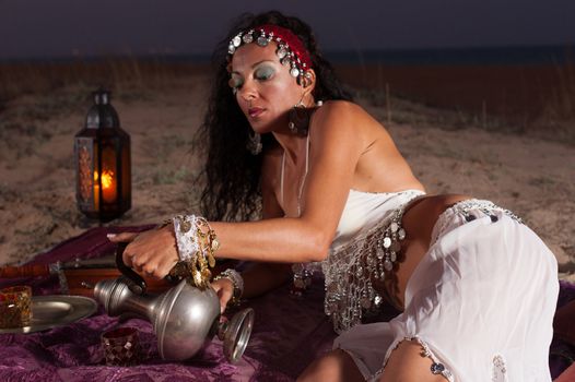 Beautiful brunette serving tea in an African setting