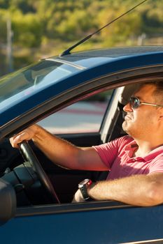 Male driver in a cool macho attitude