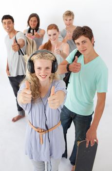 Happy teenagers smiling at the camera agaisnt white background