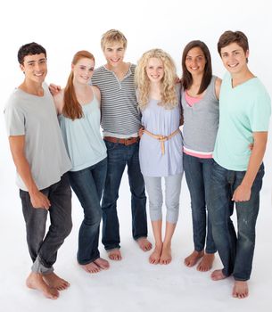 Group of smiling friends standing against white background