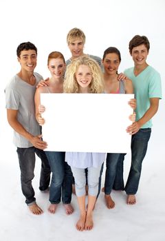 Group of teenagers holding a blank card agaisnt white background
