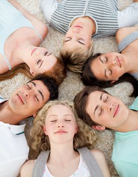 Friends with their heads together sleeping on the ground at home