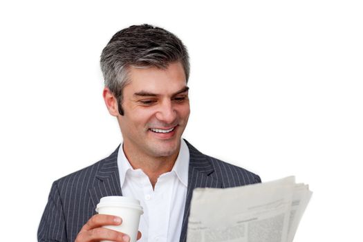 Charismatic businessman drinking a coffee while reading a newspaper against a white background