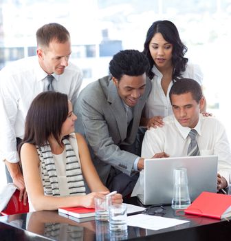Business people working together with a laptop in office