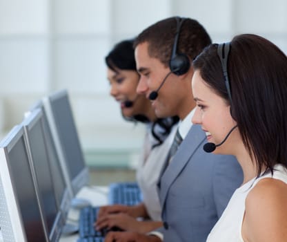 Attractive young businessman working in a call canter 