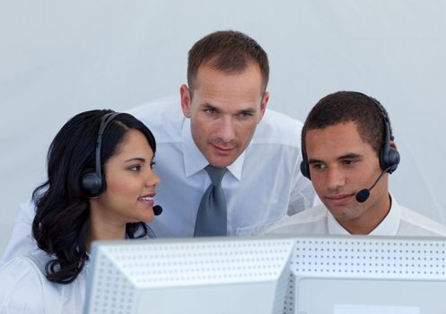 Manager helping business people working in a call canter 