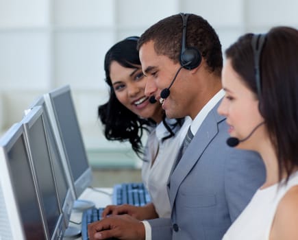 Handsome young businessman working in a call canter 