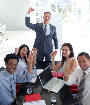 Happy business people in a meeting celebrating a success