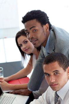 Afro-American businessman working with his team in office
