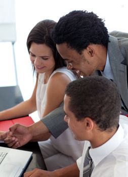 Afro-American businessman working with his colleagues in office