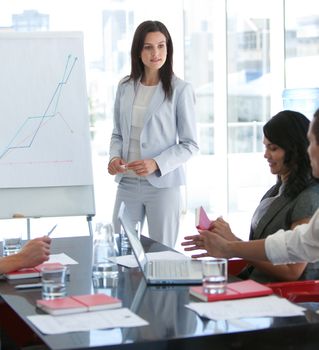 Attractive businesswoman talking to her colleague in a presentation