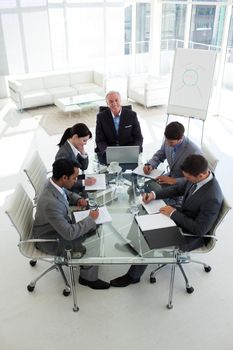 High angle of a business people showing diversity in a meeting
