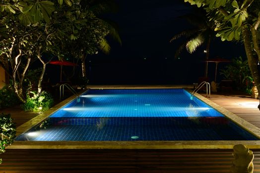 The swimming pool at night without people.