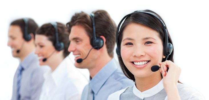 Portrait of smiling customer service agents working in a call center against a white background