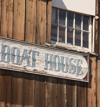 Old "Boat House" sign carved on old wooden building