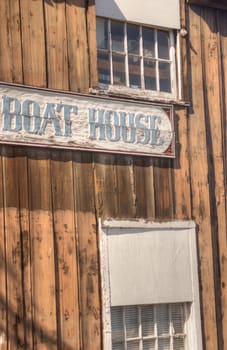 Old "Boat House" sign carved on old wooden building