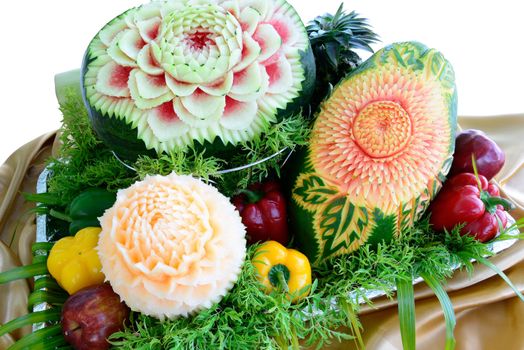 Fruit carvings by thai chef is on the buffet table,isolated on white