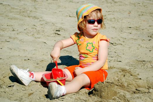 Beauty little girl playing on beach