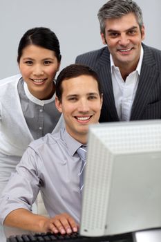 International business people working together at a computer
