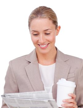 Young businesswoman drinking a coffee reading a newspaper against a white background