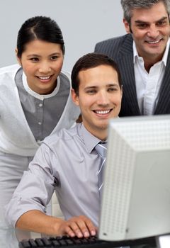 Multi-ethnic business people working together at a computer