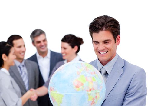 Charismatic manager and his team holding a terrestrial globe against a white background