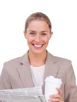 Charismatic businesswoman drinking a coffee reading a newspaper against a white background