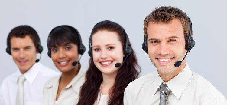 Smiling team with a headset on working in a call center