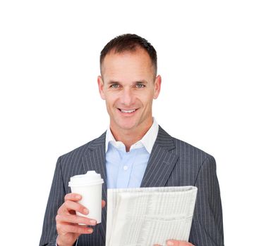 Assertive businessman reading a newspaper and holding a drinking cup 