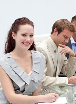 Charming businesswoman making notes in a meeting