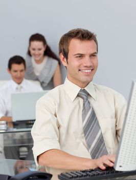 Assertive businessman working at his computer in the office