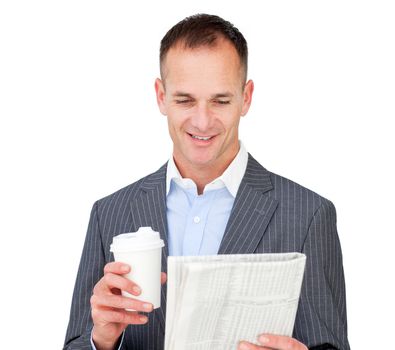 Attractive businessman reading a newspaper and holding a drinking cup 