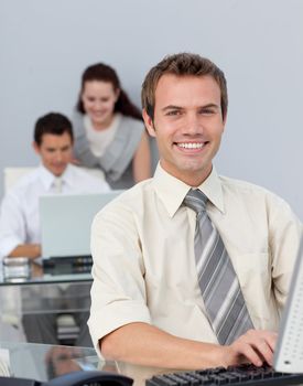 Attractive businessman working at his computer in the office