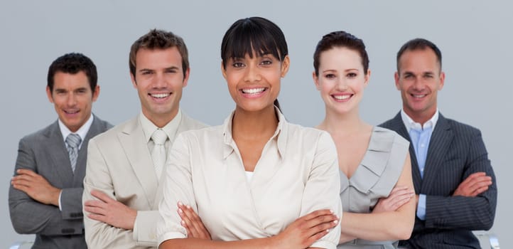 Smiling multi-ethnic young business team with folded arms