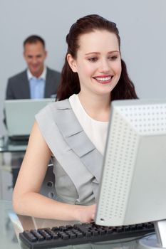 Smiling business people working at computers in the office