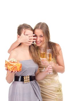 Two girls celebrate Christmas with gifts and glasses in their hands studio shooting