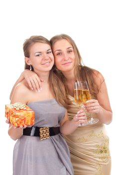 Two girls celebrate Christmas with gifts and glasses in their hands studio shooting