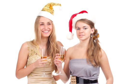 Two girls celebrate Christmas with gifts and glasses in their hands studio shooting