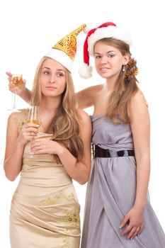 Two girls celebrate Christmas with gifts and glasses in their hands studio shooting