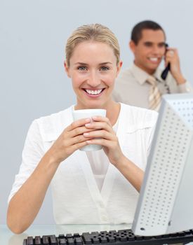 Blond woman drinking a coffee during the break in the office