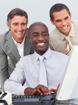 Smiling businessmen working at a computer in the office