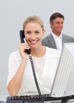 Beautiful businesswoman talking on phone in the office