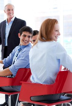 Smiling business people discussing at a conference in the office