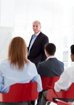 A diverse group of business people at a seminar in the office