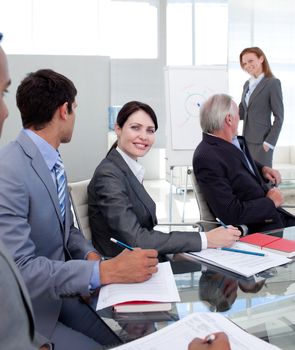 Young businesswoman studying a new business plan with her colleagues in the office