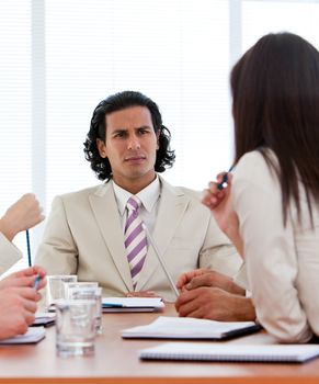 Concentrated manager talking with his team in a company